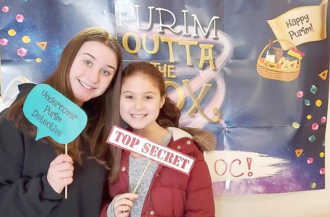 Lola Sale of Highland Mills, a volunteer at Chabad Hebrew School, gets ready to help lead the “Purim Treasure Hunt” with student Ava Lejovitzky-Reich of Harriman.