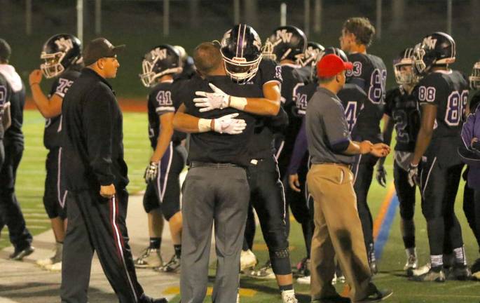 Photo by William DimmitIt&#x2019;s more than just a game: Crusader players and their coaches show emotion after their season-ending loss.
