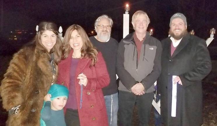 Pictured from left to right are: Nadine Pulver of Tuxedo Park, Chana Burston and her son Kovy, Ira Kanis of Monroe, Tuxedo Town Supervisor-elect Ken English and Rabbi Pesach Burston at the Tuxedo Menorah Lighting on Dec. 26.