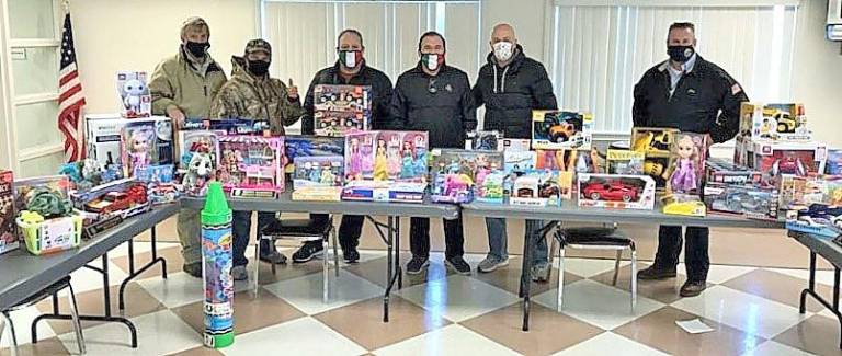 Members of the Central Orange County Italian-American Association gathered at the Dikeman Engine &amp; Hose firehouse on Dec. 15 with toys they purchased for distribution to veterans’ families. Photo by member Chris Pelligrino.