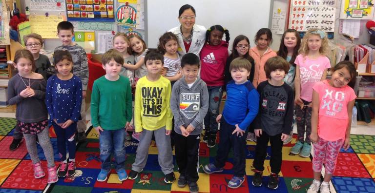 Dr. Se-A Chung with George Grant Mason School first-graders, who are now tooth brushing experts.