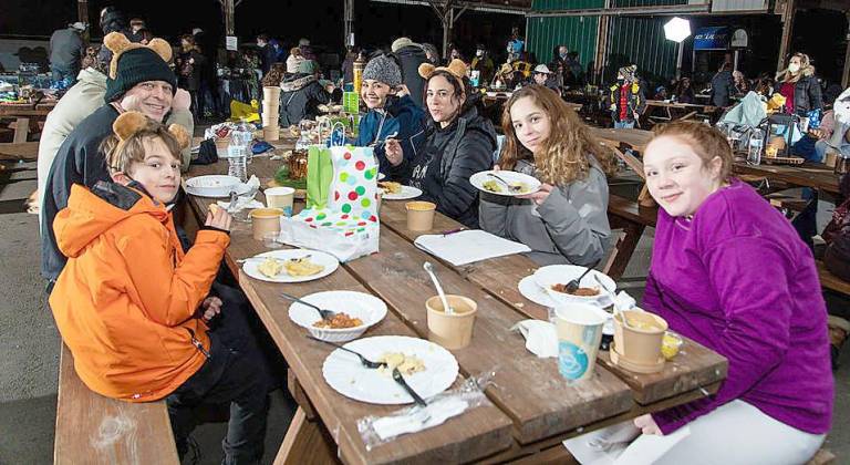 The Kalkstein Family of Monroe enjoy hot dinner in the cold at Chabad’s Purim in the Arctic.
