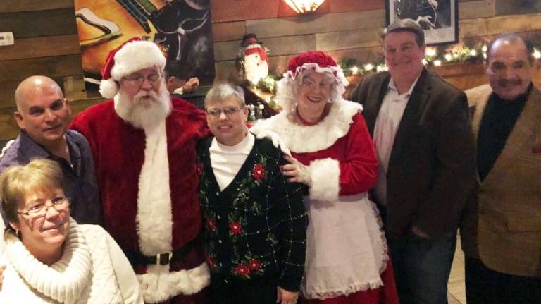 Pictured from left to right with Santa and Mrs. Claus: Monroe Town Clerk Mary Ellen Beams, Councilman Sal Scancarello, Councilwoman Mary Bingham, Councilman Mike McGinn and Councilman Rick Colon