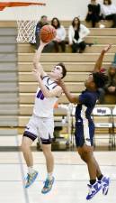 Liam Gallagher beats his defender to the basket to score two in the first quarter. Photos by William Dimmit.