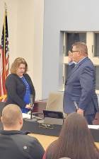 Woodbury Village Clerk Desiree Potvin also administers the oath of office Mayor Timothy Egan.