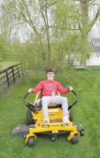 Chabad CTeen leader Gavin Reich of Highland Mills mows the lawn at the Pardess Chabad Farm at the Chabad of Orange County CTeen Volunteer day. Photos provided by Chabad of Orange County.