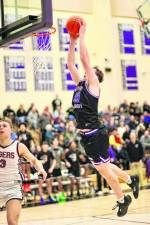 Kyle McDermott, #23, brings the Crusaders to their feet with this dunk late in the game.