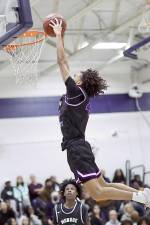 Jankarlos Mendoza brought the Crusader crowd to its feet with this dunk in the second half against Newburgh. Photos by William Dimmit.