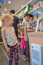 <b>Joni Clawson, 5, of Sandyston</b> with her brother Leo, 8, and sister Mavis, 2, look at books in the new mobile library, Dot, on Wednesday, June 18. (Photos by Theresa Esposito)