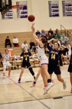 Sienna Feeley, #14, spins to the basket past a Huskie defender in the first quarter.