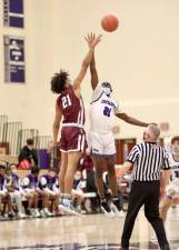 Crusader Matthew Omitiran, #21, battles for a jump ball to start the game