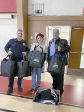 (Left to right) Chief Patrick Tenaglia, Kimberly Gutman, and Mayor Lou Medina with bags of hats and gloves they collected for the drive (1)
