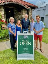 Woodbury Historical Society members from left to right: Town Historian Leslie Rose, Gatehouse Committee chairperson Joanna Calore, Trustee Walter Stanfield Jr., trustee Robert McCue, and president Alex Prizgintas stand by the new sandwich sign that will grace Route 32 and Weygant Hill Road in Highland Mills, advertising the organization’s visiting hours. Provided photo.