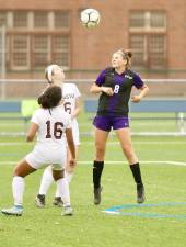 Gabrielle Mpasiakos (#8) heads the ball of a Crusader corner kick in the first half.