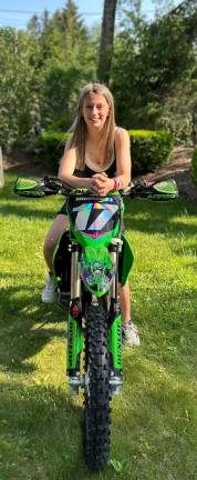West Milford’s Ella Hammett is all smiles on her Kawasaki KX112 super minibike. (Photo provided)