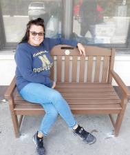 Sandy, a Highland Mills postal worker, relaxes on the Trex bench that the Lions installed next to the HM Post Office. Photo provided by Karen Ungerer.