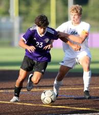 Nick Almeida (#23) battles past a Plainsman defender during Monroe-Woodbury’s home opener on Sept. 1. The game ended in a scoreless tie. Photos by William Dimmit.