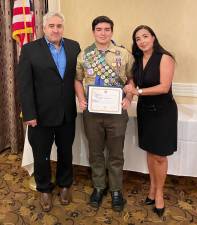 Eagle Scout Noah Sequeiros (center) with his parents Antonio and Virginia Sequeiros and his Glen A. and Melinda W. Adams Eagle Scout Service Project of the Year Award for 2022 award.