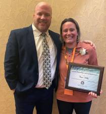 Theresa Uhelsky is congratulated by Minisink Valley Athletic Director Timothy Bult. Provided photo.