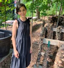 <b>Warwick gardener Aysha Venjara took first place for Best Garden this year. Here, she’s pictured with the mushrooms she grows on logs in her garden - a favorite among tour-goers. Photo by Minda Novek.</b>