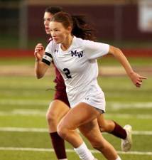 Crusader Anna Maggi (#2) beats her defender to the ball in the second half. Photos by William Dimmit.