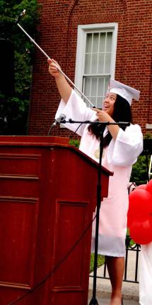Salutatorian Kelly Che extends a camera to capture a large group selfie.