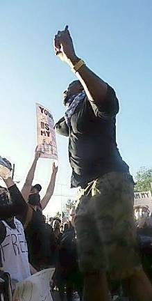 Jermaine Paul spoke to the crowd after three times around the park. People said it was an amazing turnout.