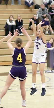 Ella Natal hits one of her three-point shots in the first half.