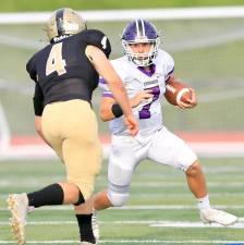 Quarterback Michael Zrelak (7) got the Crusaders started in the second half with a 38-yard run. Photos by William Dimmit.