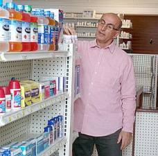 Supervising Pharmacist Jahan Keivanjah at Cure Pharmacy in Goshen checks on some of his stock. Keivanjah is welcoming the public to stop in at the pharmacy, say hello and browse. Cure Pharmacy is located at 6 North Church St. in Goshen.