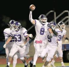 Crusader Colin Brown (#8) celebrates after scoring on a blocked Middletown punt. Photos by William Dimmit.