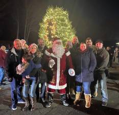 With Santa by their side, Village Mayor-elect Andrew Giacomazza and Town Supervisor-elect Thomas Burke then shared the most important duties of the night: Lighting the tree at Perrone Circle. Photos by Linda Mastrogiacomo.