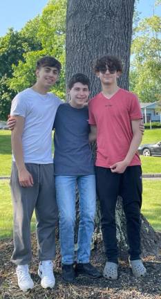 Friendship volunteers Tom Einav and Amir Mosker enjoy weekly visits with their friend Griffin Patsiner of Monroe.