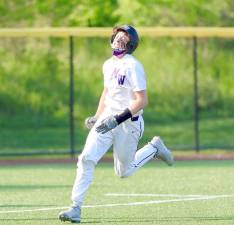 Kyle McDermott races around third to score against Burke Catholic. Photos by William Dimmit.