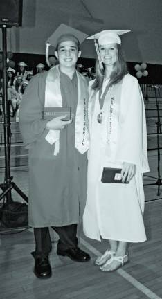 Photo by Ed Bailey George F. Baker High School valedictorian Andrew Ehlers and salutatorian Sara Neyman oblige a photographer during their graduattion ceremony last Friday. The ceremony was moved from the high school in Tuxedo to the Middle School in Greenwood Lake because of expected bad weather.