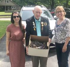 Pictured from left to right are: Marisa Dollbaum, Charles Pakula and Ginny O’Neill with more than 120 pairs of glasses donated to the Lions Club in Monroe by residents of the Town of Tuxedo. Provided photo.
