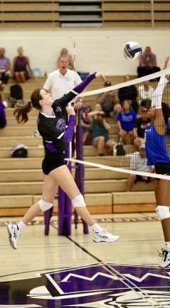 Amelia Turner spikes a shot over the net.