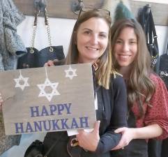 Tawnya Muhlrad of Goshen, pictured with Chana Burston, displays the Chanukah decoration she created.