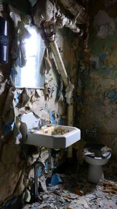 A ruined bathroom in the Infirmary building is framed as an artistic portrait of abandonment and decay. Courtesy of Robert Yasinsac / Hudson Valley Ruins.