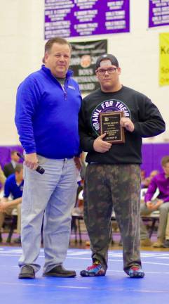 Photos by William Dimmit Crusader Preston Havison receives the Patrick Michael Daliso Most Improved Wrestler Award from Tom Kennedy before the finals on Saturday.