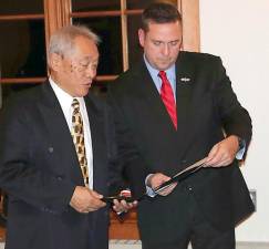 Orange County Executive Steven M. Neuhaus presents a Meritorious Service Award to Wayne Chan from the Monroe Volunteer Ambulance Corps.