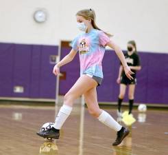 Cassidy Maher moves the ball during a quick-passing drill. Photos by William Dimmit.
