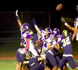 Crusader defensive end Nicolas Montero, #80, tries to block a Bushmen’s PAT in the first quarter.