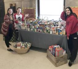 This fall, the Tuxedo School District National Honor Society and National Junior Honor Society collected 450 food items for local food pantries. The Honor Societies are committed to our communities and do five community service drives throughout the year. The next drive has already begun. It is a hat and glove drive for Rockland County's People to People's Clothes Closet. Please feel free to drop donations to the collection table in the GFB Upper School front hall. Pictured from left to right with the donations are Honor Society officers Grace Rinaldo, Madison Spivak and Julia Ruscillo.