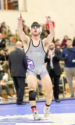 Joe McGinty celebrates after pinning his opponent and claiming his second consecutive Section 9 Title.