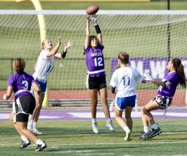 Monroe-Woodbury’s Chloe Ahorrio (#12) catches a pass for a touchdown early in the Section IX Flag Football playoff game at Monroe.