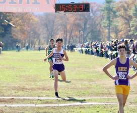 Photos by William Dimmit Crusader Andrew Yi crosses the finish line in third place in the Class A race.