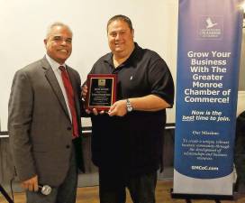 Edison Guzman, president of the board of the Greater Monroe Chamber of Commerce, presents David Wenger of Empire Diner with the chamber's Business Community Award for his contributions throughout the Monroe-Woodbury community.