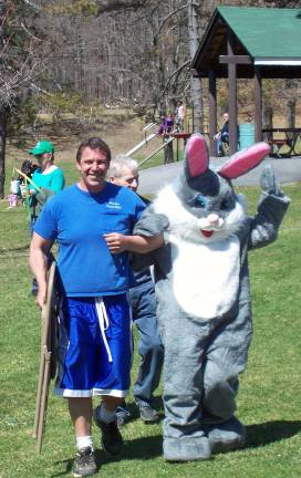 Photos provided by Joe Mancuso John Wetland escorts the Easter Bunny to the festivities at Smith's Clove Park in Monroe last Saturday, April 12.