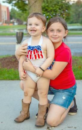 The Fourth of July is for sisters - and cowboy boots, such as the Craig sisters from Goshen: Kelly, 2, and Erin, 8.